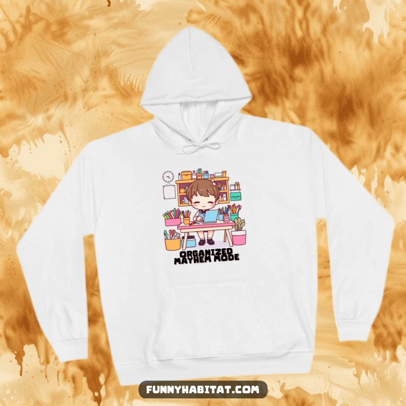 Funny hoodie depicting a character tidying a vibrant craft desk, perfect for cozy crafting sessions and a good laugh.