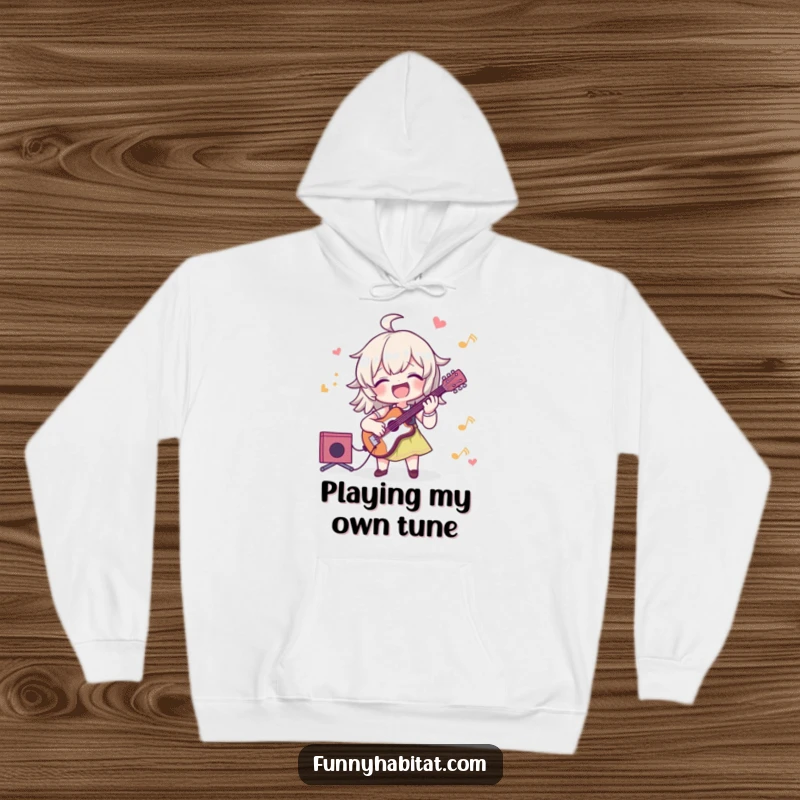 Funny hoodie with a character joyfully playing a musical instrument, designed for cozy comfort and a touch of musical humor.